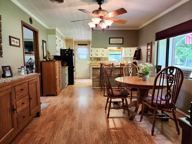 493 Hideaway Loop, Hemphill, TX 75948 - dining space with light wood-style flooring, ornamental molding, plenty of natural light, and ceiling fan