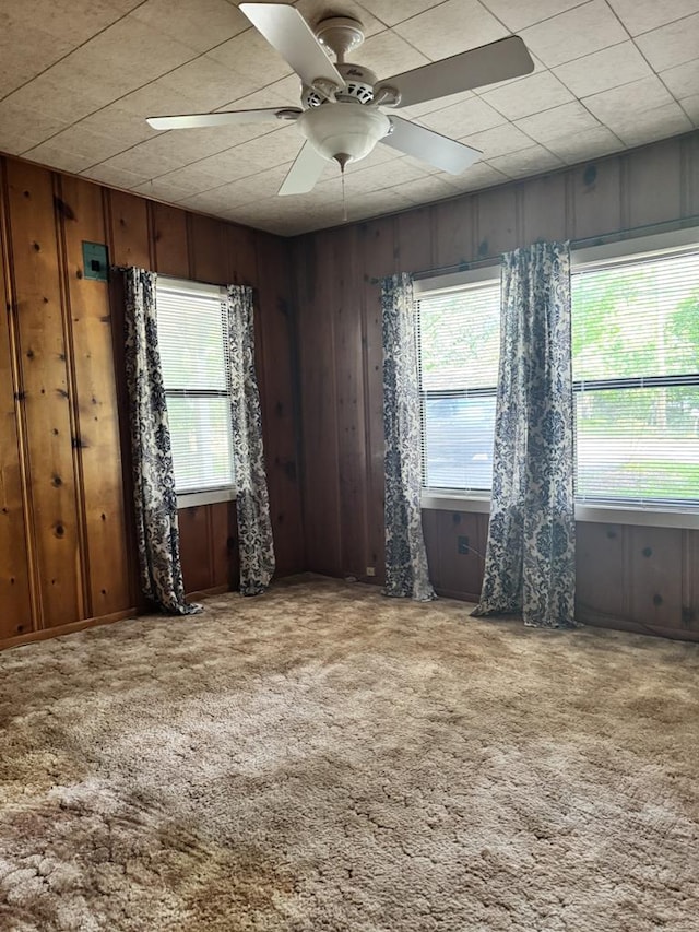 2006 Palmore Rd, Lufkin, TX 75904 - carpeted spare room featuring wooden walls and a ceiling fan