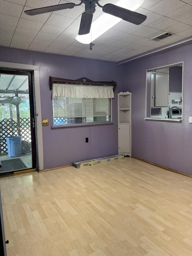 2006 Palmore Rd, Lufkin, TX 75904 - unfurnished room featuring ceiling fan, wood finished floors, baseboards, and a sink