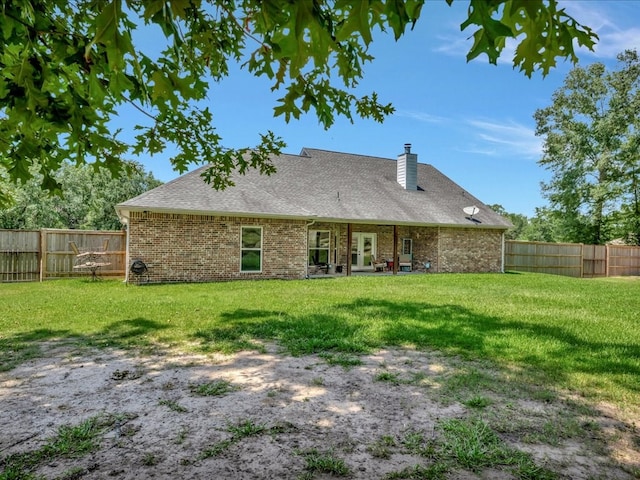166 White Oak Ln, Lufkin, TX 75904 - back of property featuring brick siding, a chimney, a fenced backyard, and a shingled roof