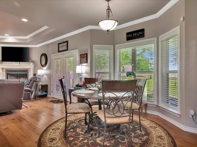 166 White Oak Ln, Lufkin, TX 75904 - dining space with crown molding, wood finished floors, a fireplace, and french doors