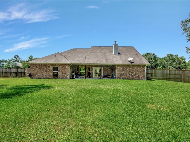 166 White Oak Ln, Lufkin, TX 75904 - rear view of property with a fenced backyard, brick siding, and a chimney