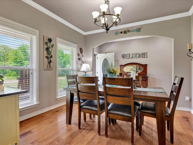 166 White Oak Ln, Lufkin, TX 75904 - dining area featuring arched walkways, a chandelier, light wood-style flooring, and crown molding