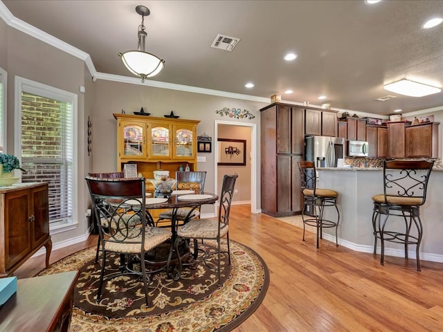 166 White Oak Ln, Lufkin, TX 75904 - dining area featuring ornamental molding, light wood-type flooring, and recessed lighting