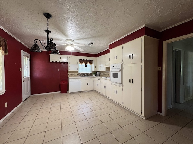 kitchen featuring light tile patterned floors, white appliances, white cabinetry, and ornamental molding