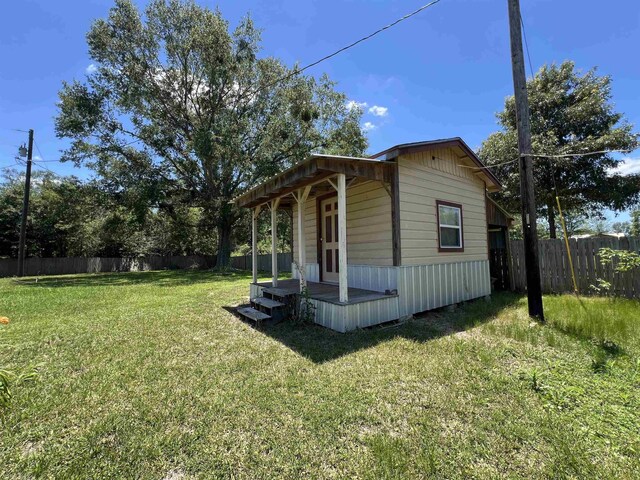 view of side of property with a lawn