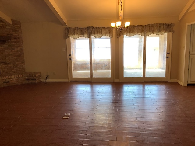 204 Primrose Ln, Hemphill, TX 75948 - spare room featuring dark wood finished floors, beamed ceiling, and a chandelier