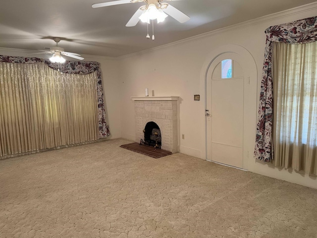 unfurnished living room featuring carpet, ceiling fan, and ornamental molding