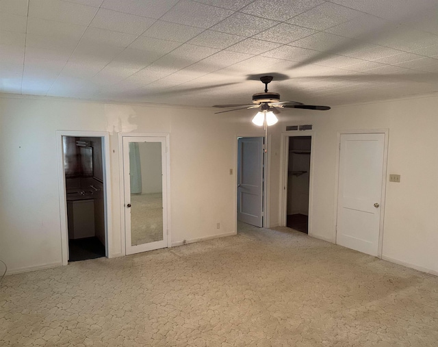 unfurnished bedroom featuring carpet flooring and ceiling fan