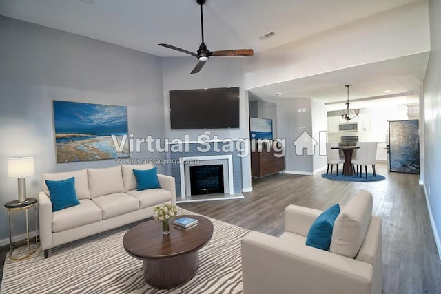 322 Montrose, Lufkin, TX 75901 - living room with wood finished floors, baseboards, a ceiling fan, and a fireplace with raised hearth