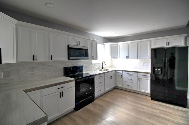 322 Montrose, Lufkin, TX 75901 - kitchen featuring black appliances, a sink, light countertops, tasteful backsplash, and white cabinetry