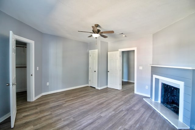 unfurnished living room with ceiling fan, dark hardwood / wood-style flooring, and a textured ceiling