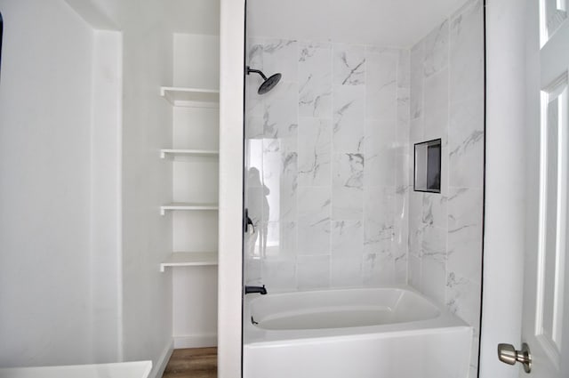 bathroom featuring tiled shower / bath and wood-type flooring