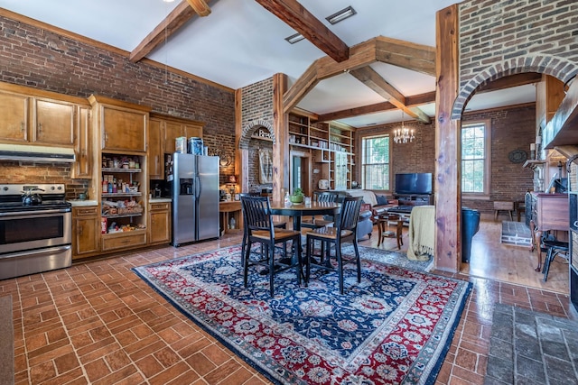 interior space featuring an inviting chandelier, appliances with stainless steel finishes, brick wall, hanging light fixtures, and beam ceiling