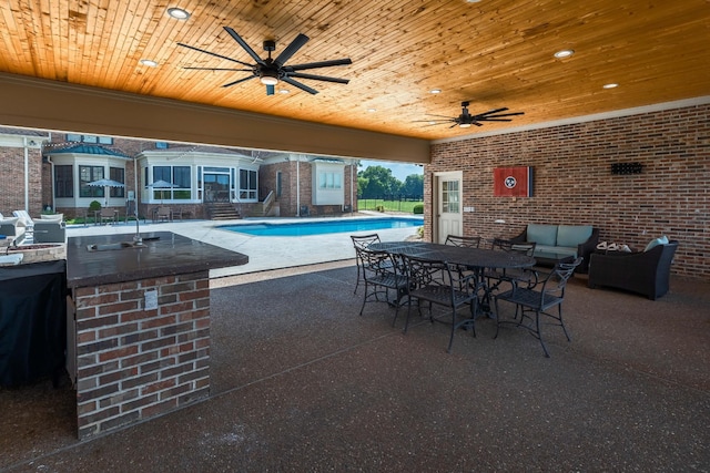 view of terrace featuring ceiling fan and exterior kitchen