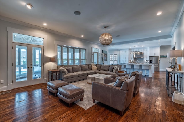 living room with crown molding, sink, dark wood-type flooring, and french doors