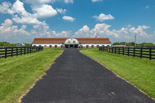 exterior space with a front lawn and a rural view