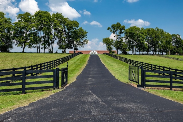 view of gate featuring a yard and a rural view