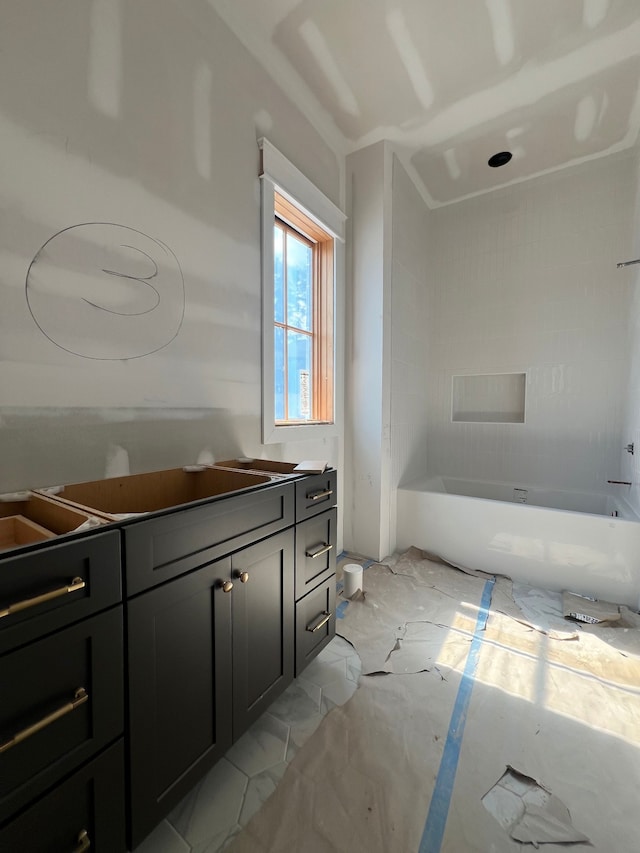 bathroom featuring vanity and a bath