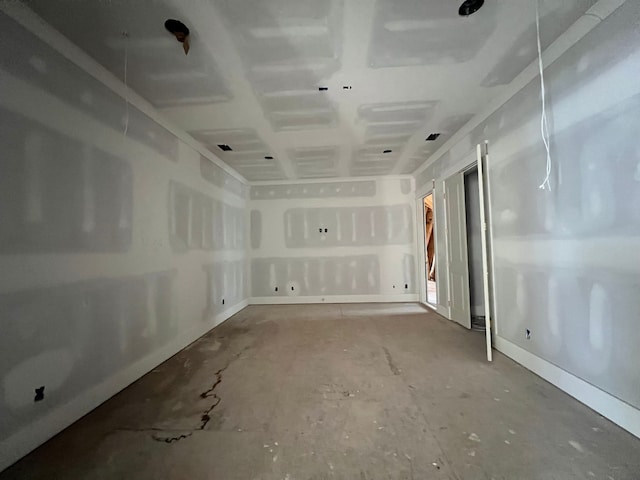 unfurnished room with concrete flooring