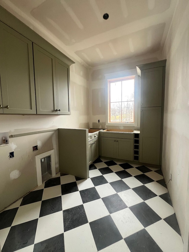 laundry room featuring cabinet space and light floors