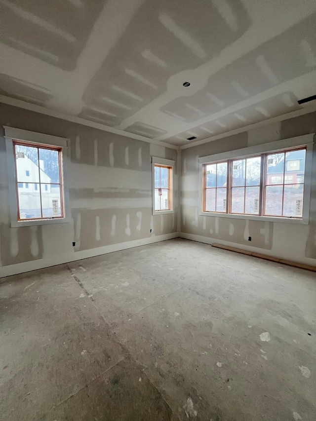 unfurnished room featuring baseboards