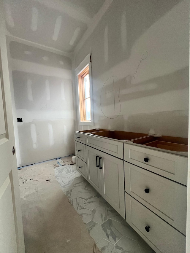 bathroom with marble finish floor and vanity