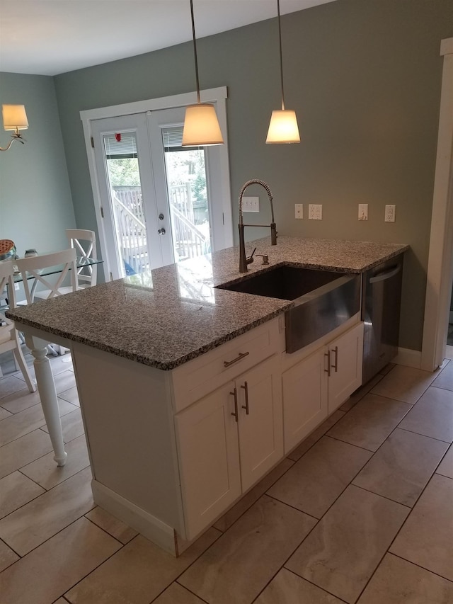 kitchen featuring white cabinets, light stone counters, light tile floors, decorative light fixtures, and french doors