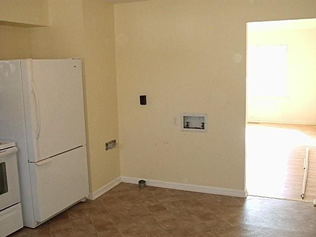 laundry area featuring washer hookup and light tile floors