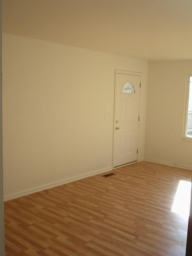 unfurnished room featuring light wood-type flooring