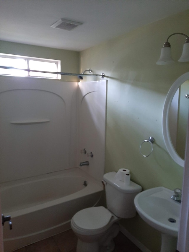 full bathroom featuring shower / bathtub combination, tile floors, toilet, and sink