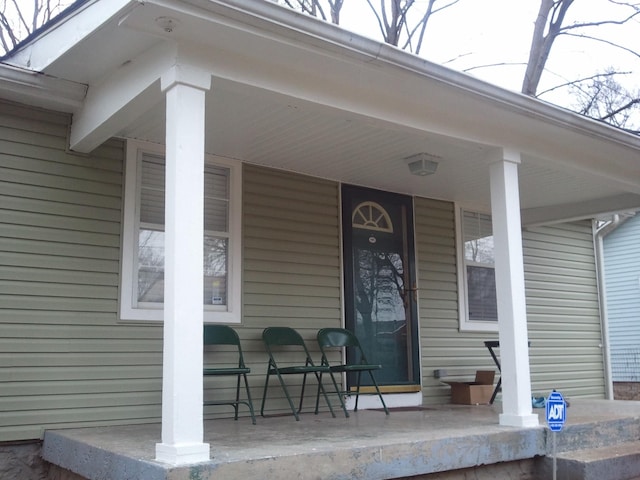 view of exterior entry with covered porch