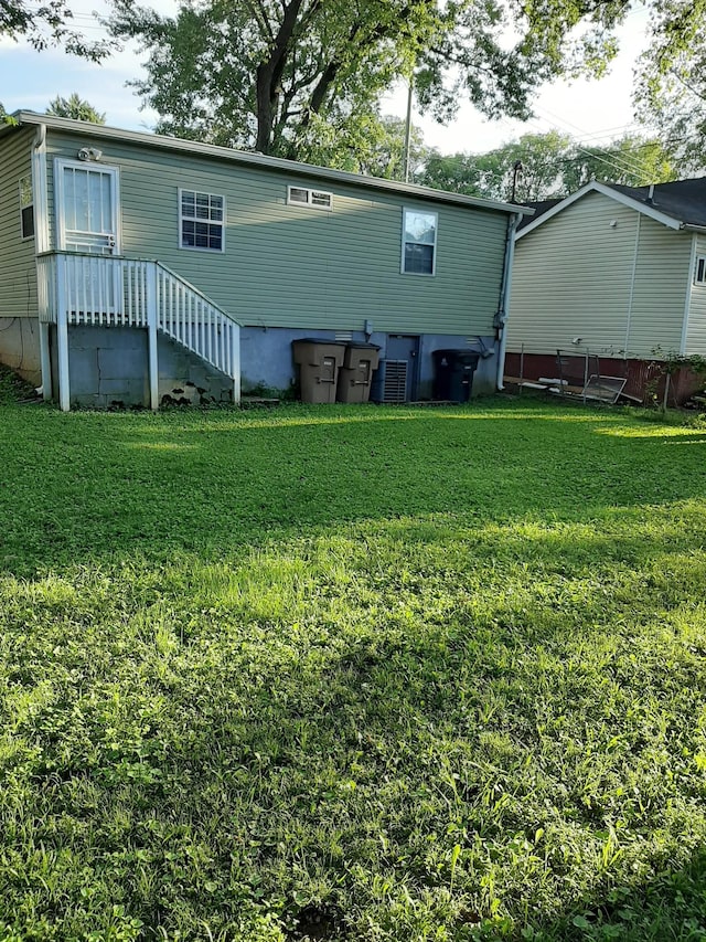 back of property featuring a yard