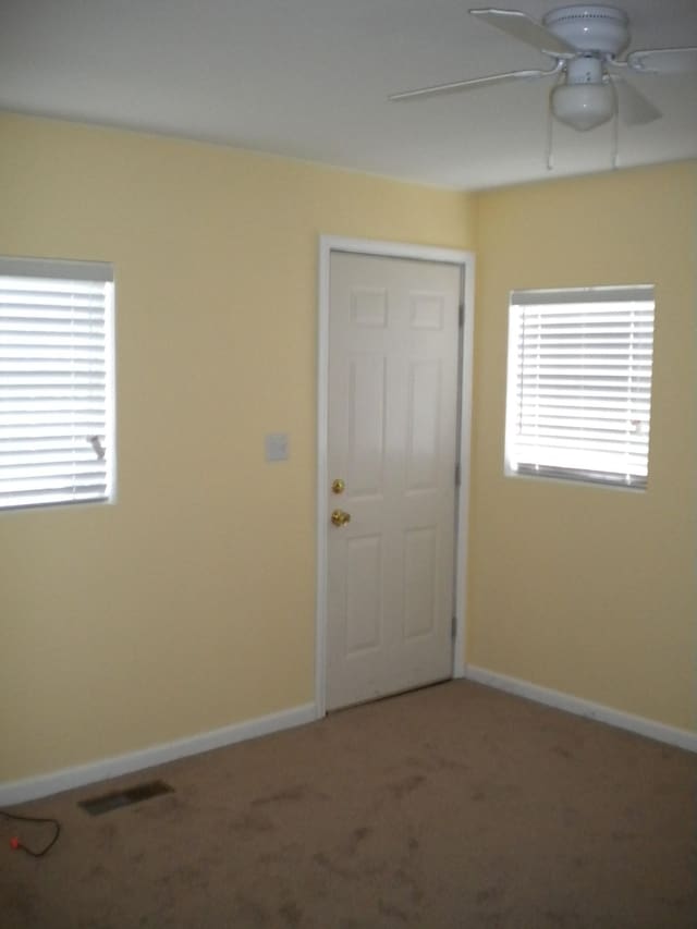 carpeted empty room with ceiling fan