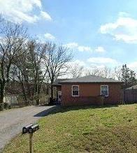 view of side of property featuring a yard