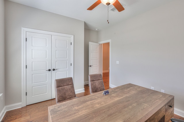 dining space with wood-type flooring and ceiling fan