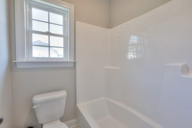 bathroom with bathtub / shower combination and toilet