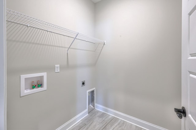 laundry area with hookup for a washing machine, light hardwood / wood-style flooring, and electric dryer hookup