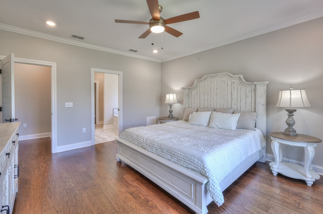 bedroom with ornamental molding, dark hardwood / wood-style flooring, ceiling fan, and ensuite bath