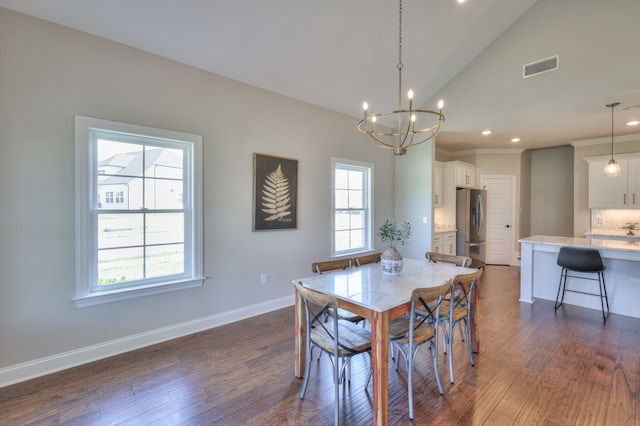 dining space featuring a chandelier, dark hardwood / wood-style floors, and lofted ceiling