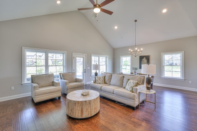 living room featuring high vaulted ceiling, dark hardwood / wood-style flooring, and ceiling fan with notable chandelier