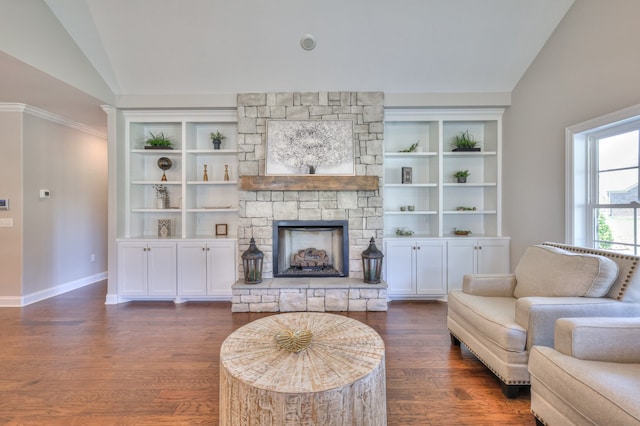 living room featuring dark hardwood / wood-style flooring, lofted ceiling, a fireplace, and built in shelves