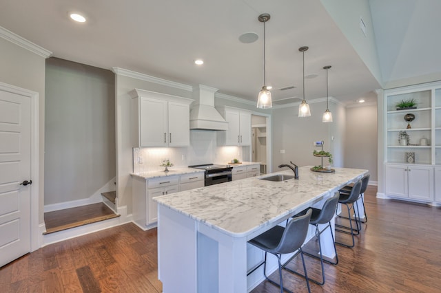 kitchen with stainless steel range with electric stovetop, premium range hood, a kitchen island with sink, and dark hardwood / wood-style floors