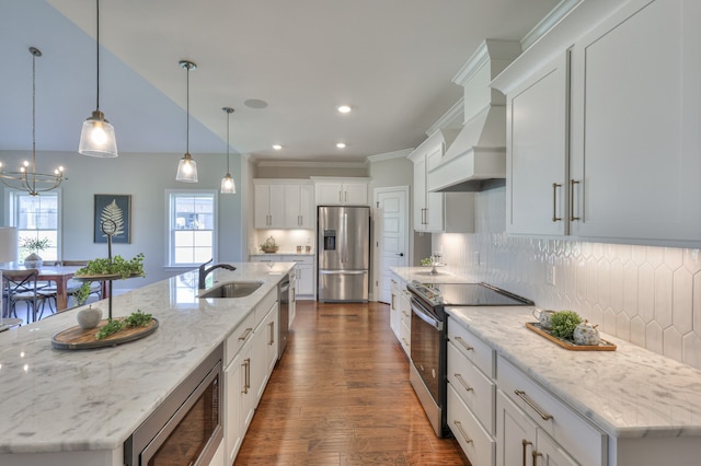 kitchen featuring a large island with sink, tasteful backsplash, stainless steel appliances, and sink