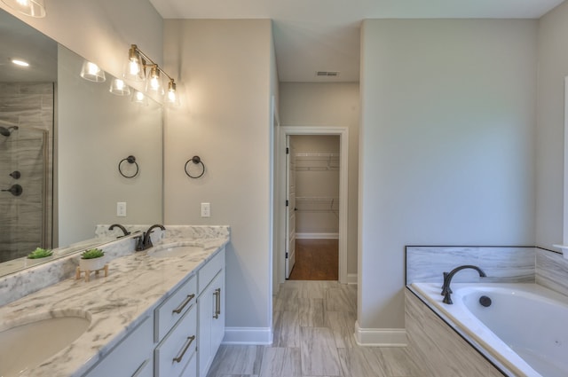 bathroom featuring dual bowl vanity, tile flooring, and separate shower and tub