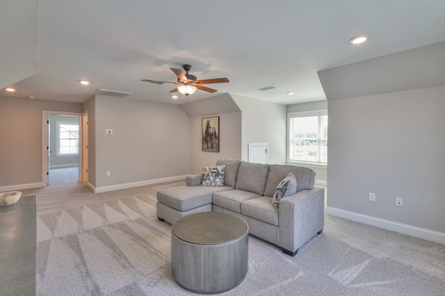 living room featuring ceiling fan and a healthy amount of sunlight