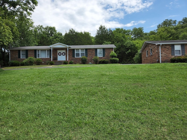 ranch-style home with a front lawn