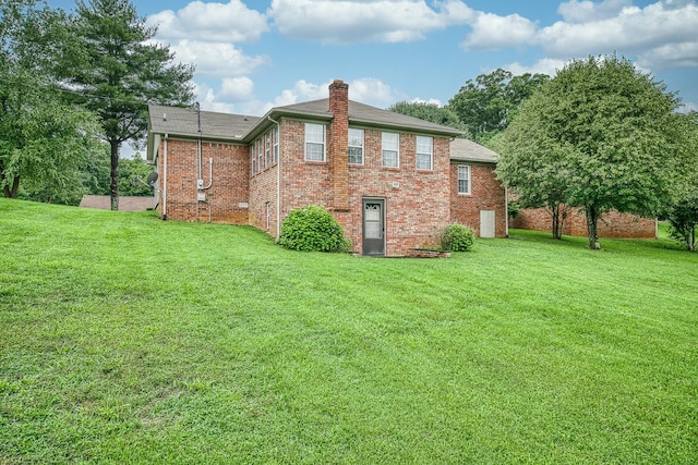 rear view of property with a yard