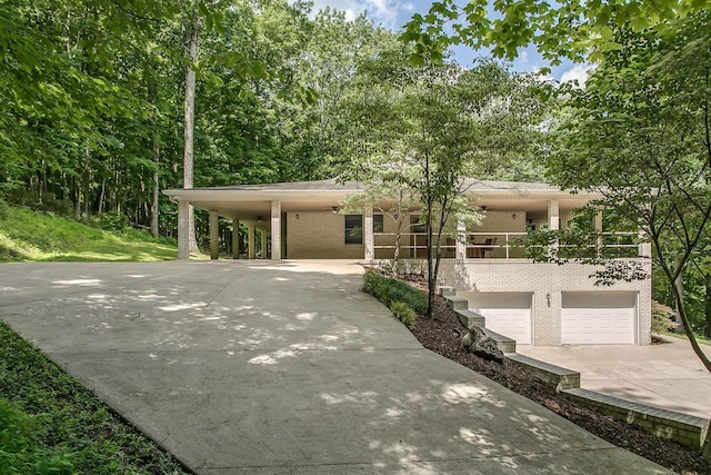 view of front facade featuring a balcony, a carport, and a garage