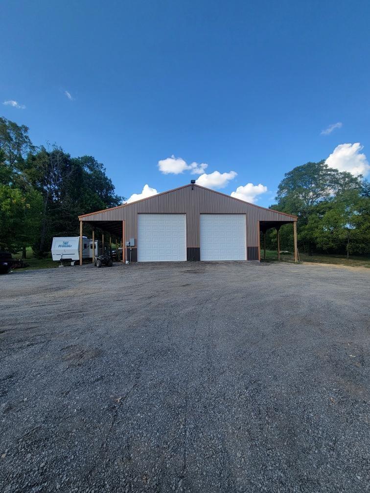 view of side of home featuring a carport and a garage